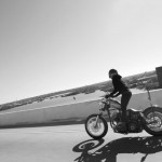 woman riding classic harley davidson motorcycle custom - brat style