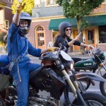 Tori (left) and Emily George wave hello on their dual sport style motorcycles in Portland
