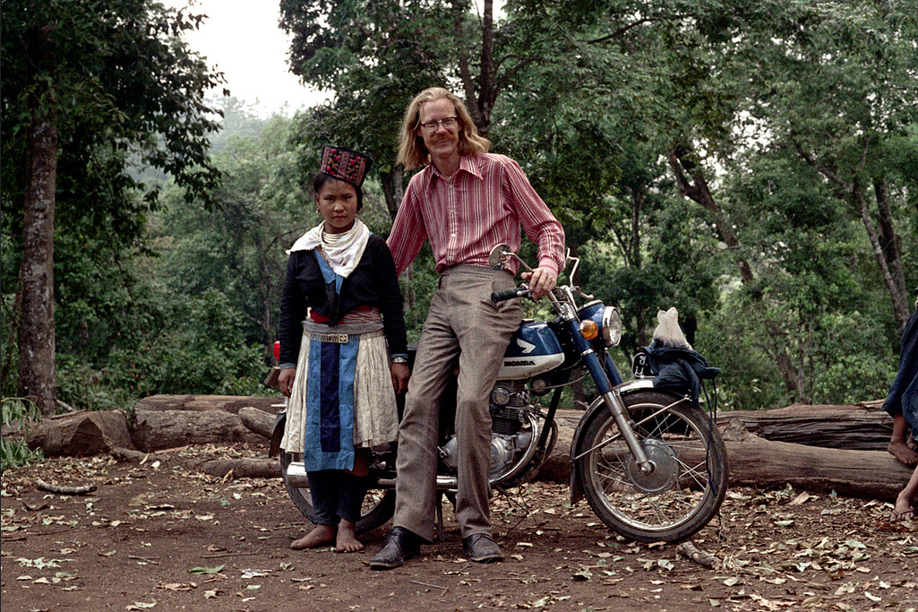 Nick DeWolf posing with a young girl on his travels in Northern Thailand