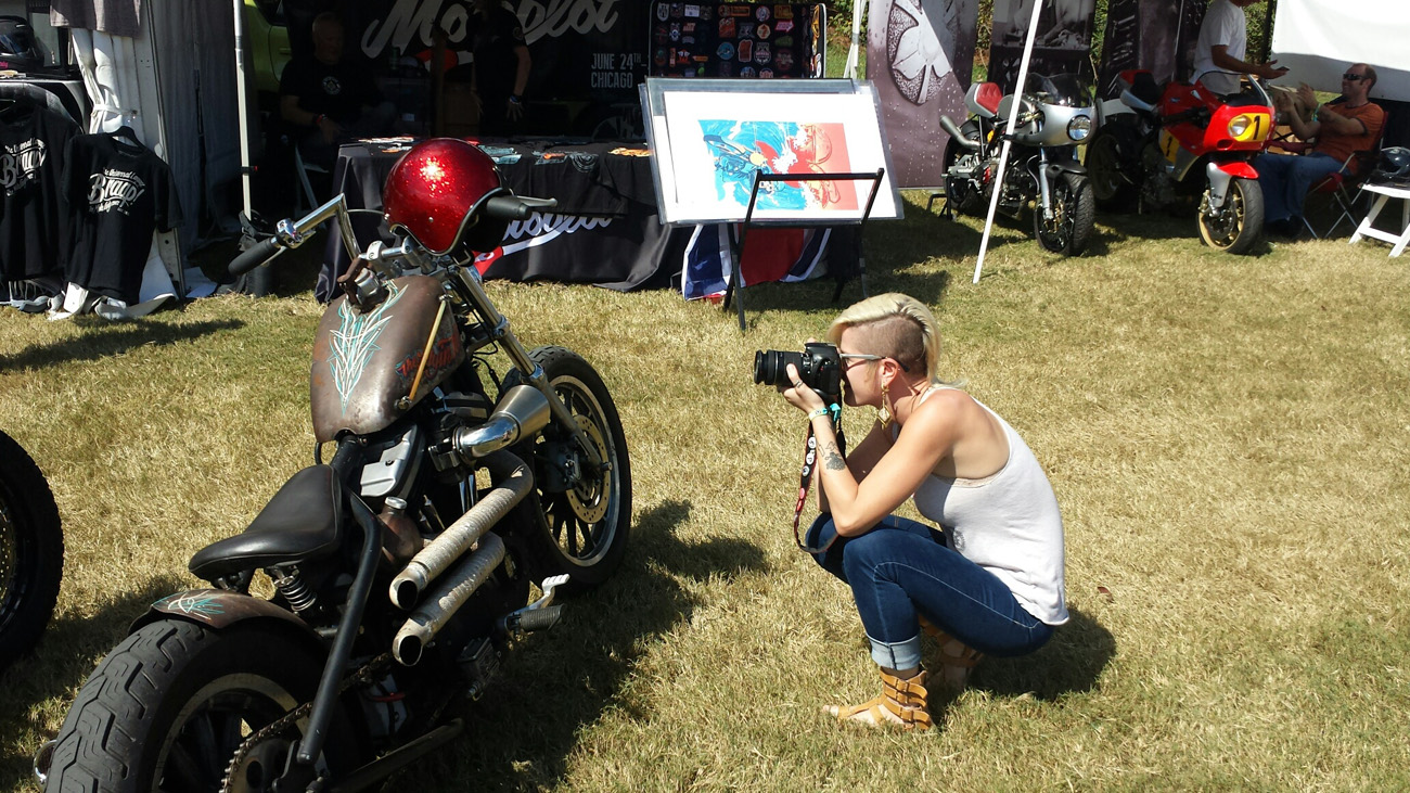 Alicia Elfving of MotoLady photographing bikes at Barber Vintage Festival