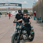 Builder and racer Malary Lee rides her Royal Enfield BuildTrainRace bike out of the NASCAR garage